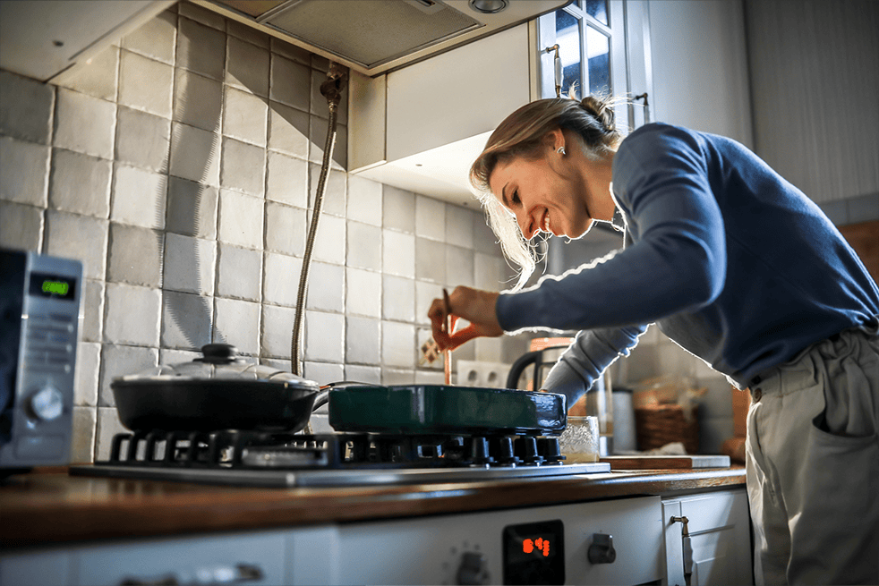 Woman cooking over stove
