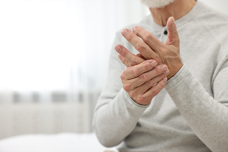 Man holding finger in pain