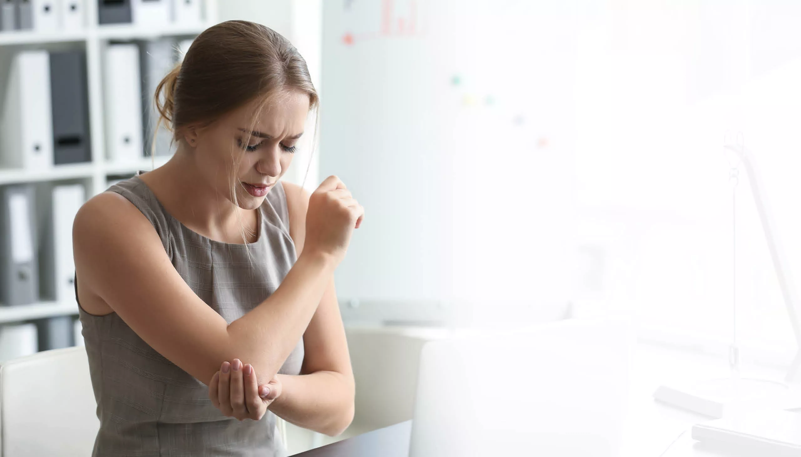 Woman experiencing pain in her elbow