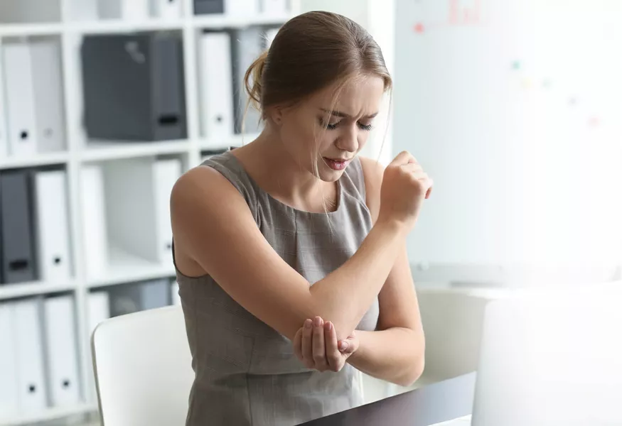 Woman experiencing pain in her elbow